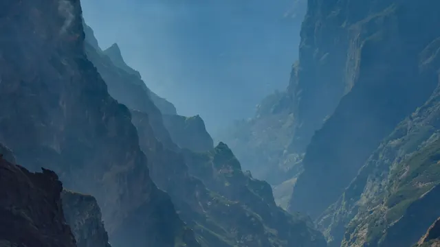 Jagged volcanic peaks rising above a sea of cloud, seen from Pico do Arieiro in Madeira