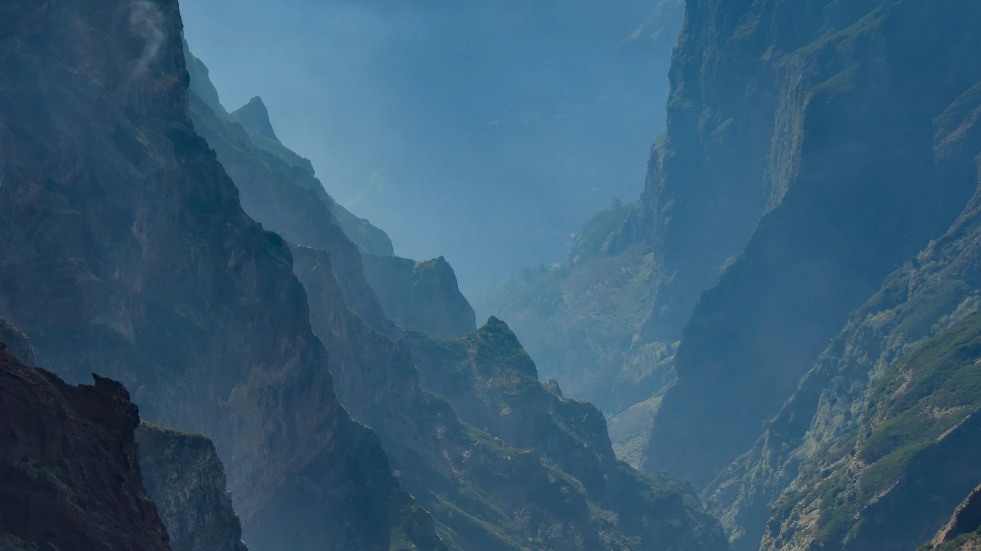 Jagged volcanic peaks rising above a sea of cloud, seen from Pico do Arieiro in Madeira